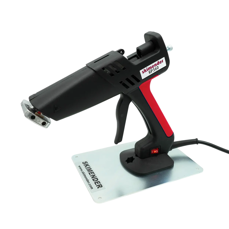 Load image into Gallery viewer, Heißklebepistole mit schwarzem und rotem Griff auf Metallplatte mit der Aufschrift 'SKIMENDER'