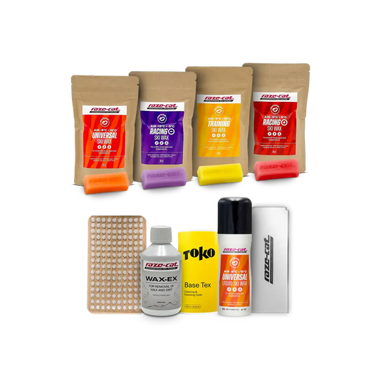 Mehrere Packungen Skiwachs in verschiedenen Farben und Typen, darunter Universal, Racing und Training, mit Zubehör wie Bürste, Flüssigwachs, Basiswachs und Wachsschaber.